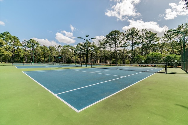 view of tennis court featuring fence