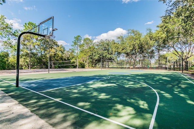 view of basketball court with community basketball court, volleyball court, and fence