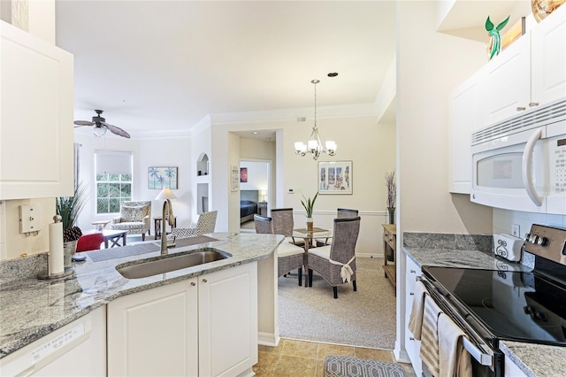 kitchen with white appliances, a sink, and white cabinets