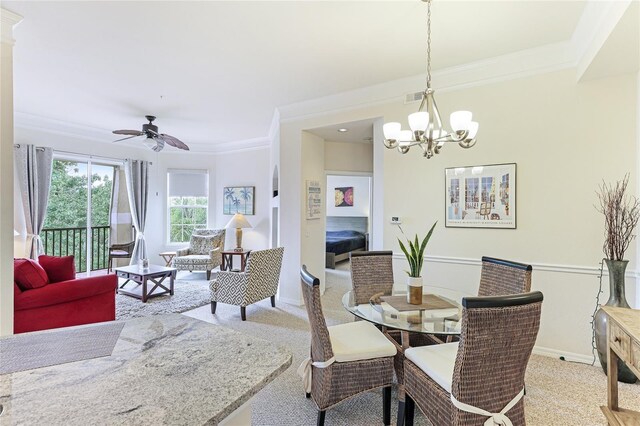 dining space with ceiling fan with notable chandelier, light carpet, and ornamental molding