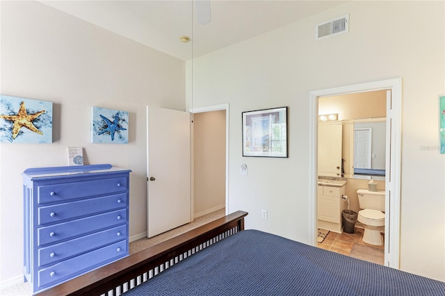 bedroom featuring ceiling fan and ensuite bath