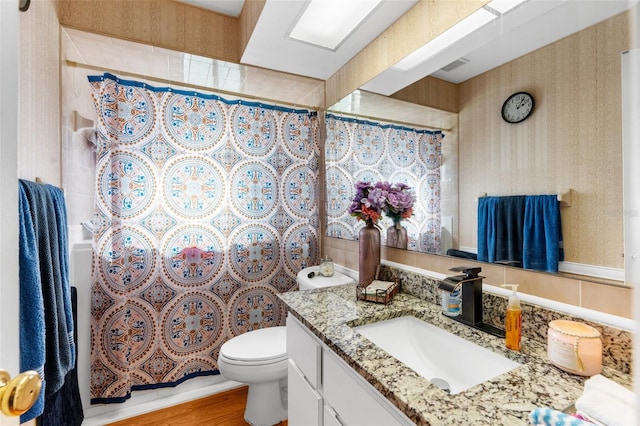 full bathroom with vanity, toilet, shower / tub combo with curtain, and wood-type flooring