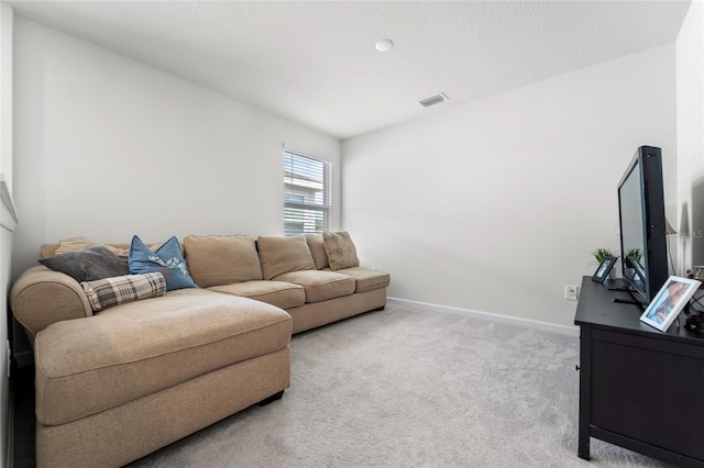 living area featuring light colored carpet, baseboards, and visible vents