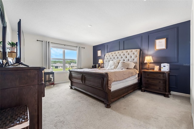 bedroom with light carpet and baseboards