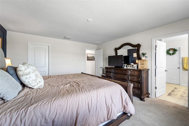 bedroom with light carpet and visible vents