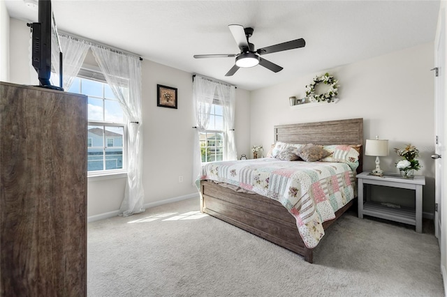 bedroom featuring carpet floors, baseboards, and ceiling fan