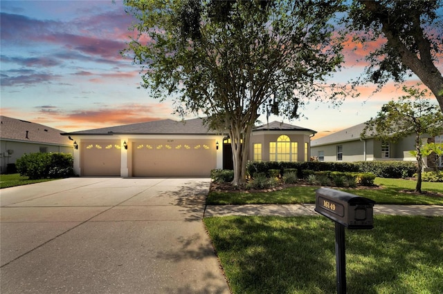 view of front facade with a yard and a garage