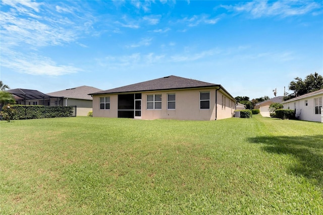 rear view of house with a yard