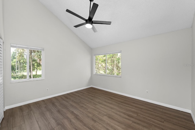 empty room featuring ceiling fan, dark wood-type flooring, and high vaulted ceiling