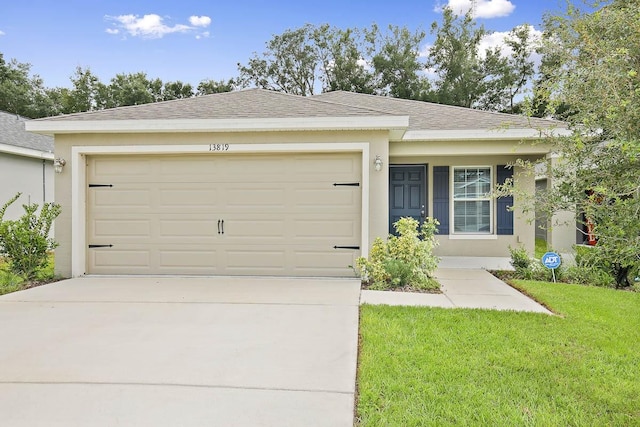 view of front of home featuring a garage and a front yard