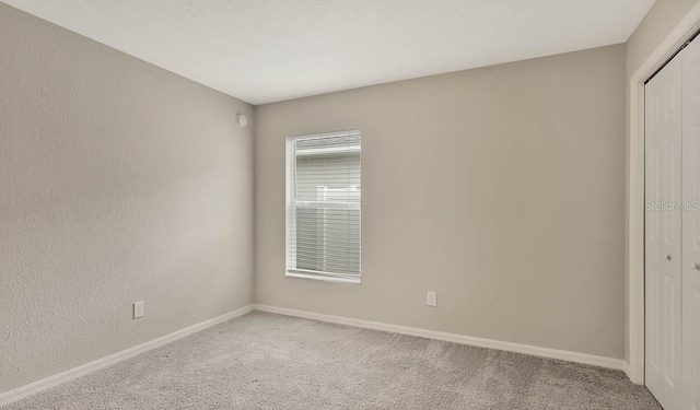 unfurnished bedroom with a closet and carpet floors