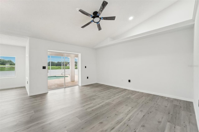 empty room featuring lofted ceiling, light hardwood / wood-style floors, and ceiling fan