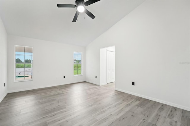 unfurnished room featuring ceiling fan, high vaulted ceiling, and light wood-type flooring