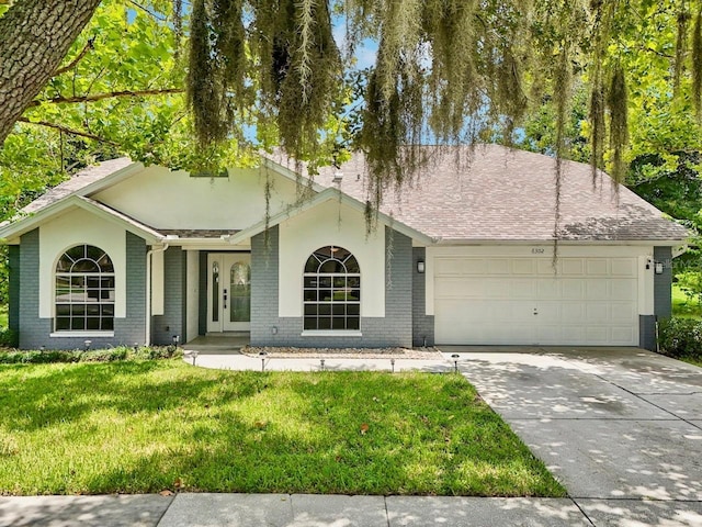 single story home with a garage and a front yard