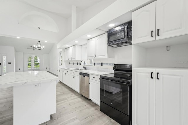 kitchen with a kitchen island, dishwasher, white cabinets, decorative backsplash, and black range with electric stovetop