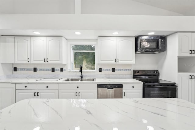 kitchen featuring white cabinetry, vaulted ceiling, sink, and black appliances