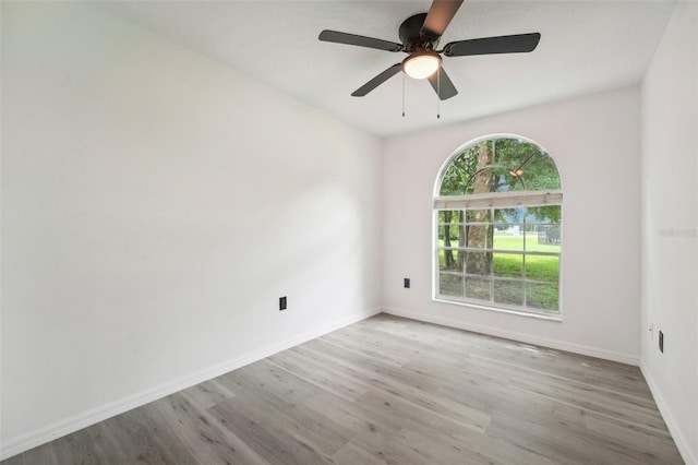 unfurnished room featuring ceiling fan, light hardwood / wood-style flooring, and a wealth of natural light