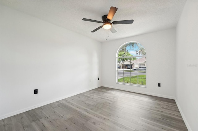 spare room with ceiling fan and hardwood / wood-style floors