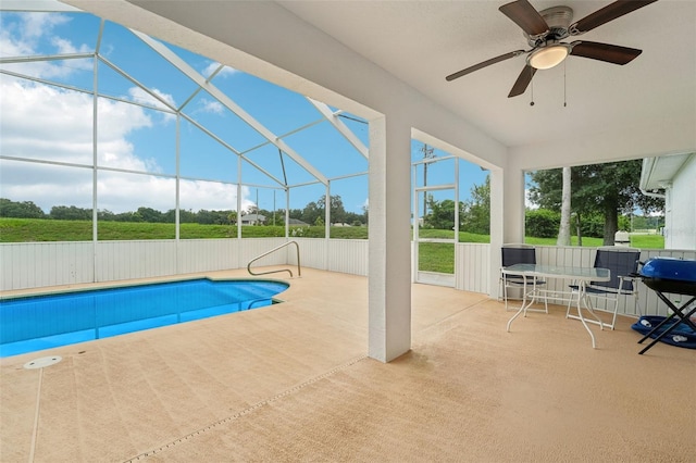 view of pool with ceiling fan, a patio, and glass enclosure