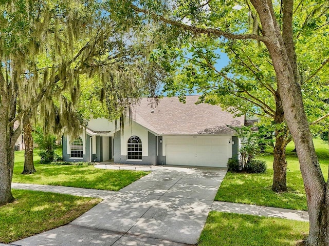 view of front of home with a garage and a front yard