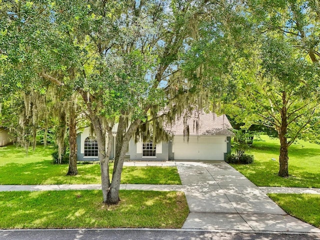 obstructed view of property with a garage and a front yard