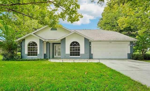 ranch-style house with a garage and a front lawn