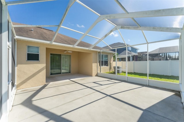 unfurnished sunroom featuring lofted ceiling and ceiling fan