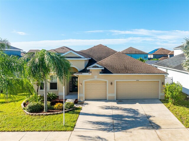 view of front of house with a garage and a front lawn