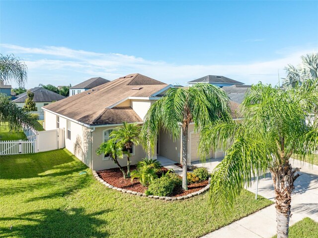 view of front of property featuring a garage and a front lawn