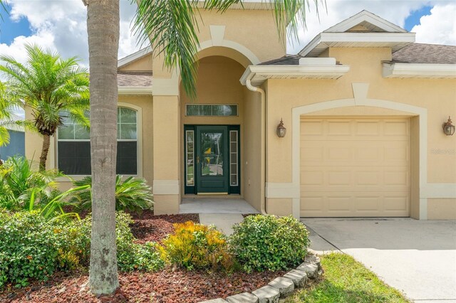 doorway to property with a garage