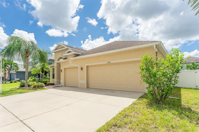 view of front of property featuring a garage and a front yard