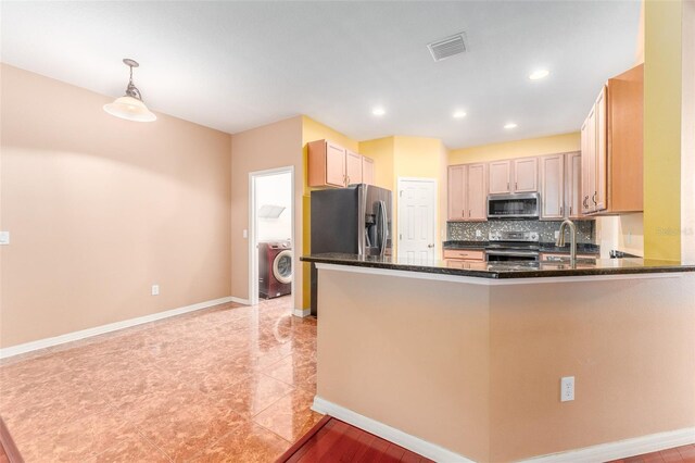 kitchen with hanging light fixtures, light brown cabinetry, light tile patterned floors, and appliances with stainless steel finishes