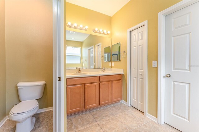 bathroom featuring tile patterned floors, toilet, and vanity