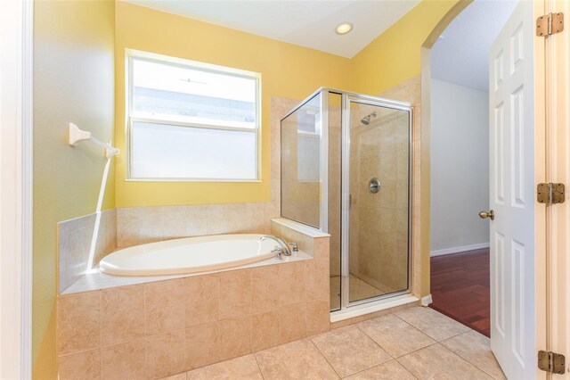 bathroom featuring plus walk in shower and tile patterned flooring