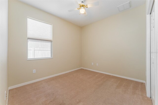 carpeted empty room featuring ceiling fan