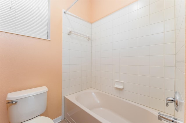 bathroom with toilet and tiled shower / bath combo