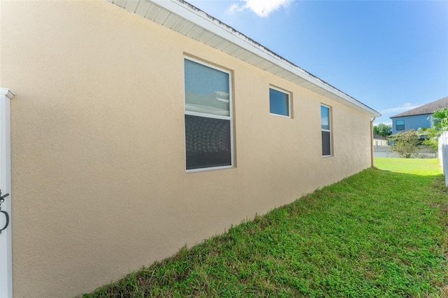 view of side of property with a lawn