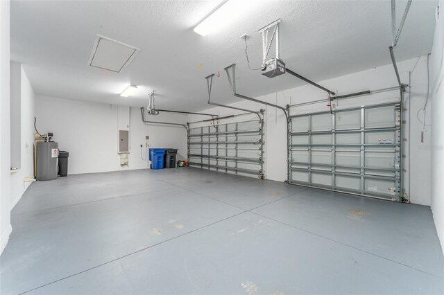 garage with a garage door opener, electric panel, and water heater