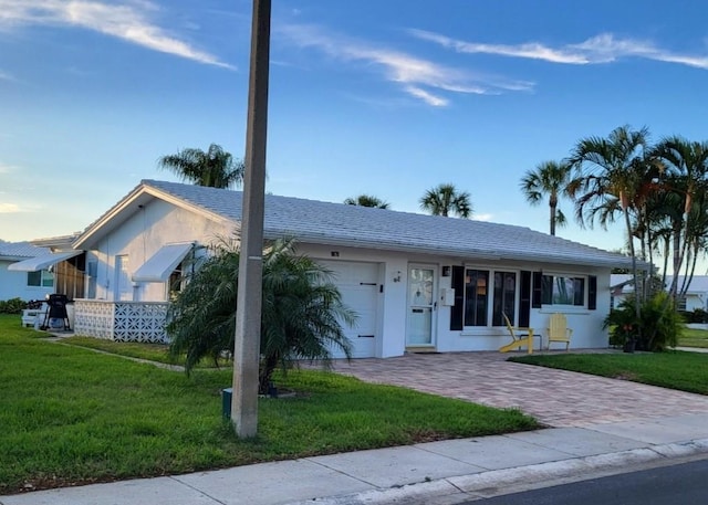 single story home with a garage and a front yard