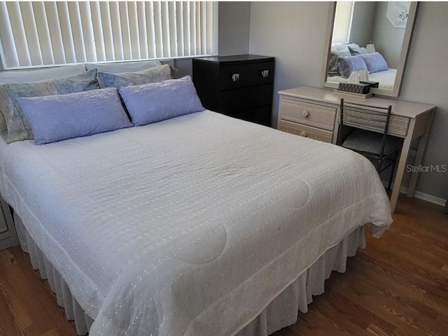 bedroom featuring dark hardwood / wood-style flooring