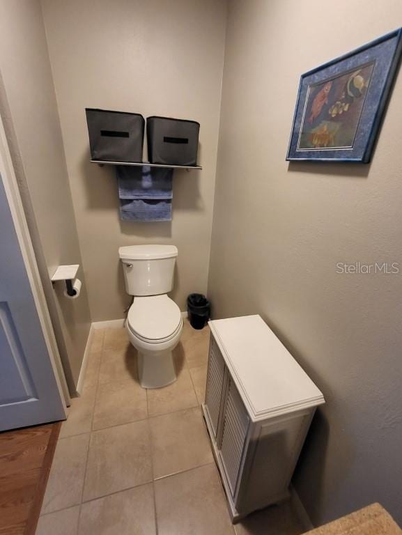 bathroom featuring tile patterned flooring and toilet