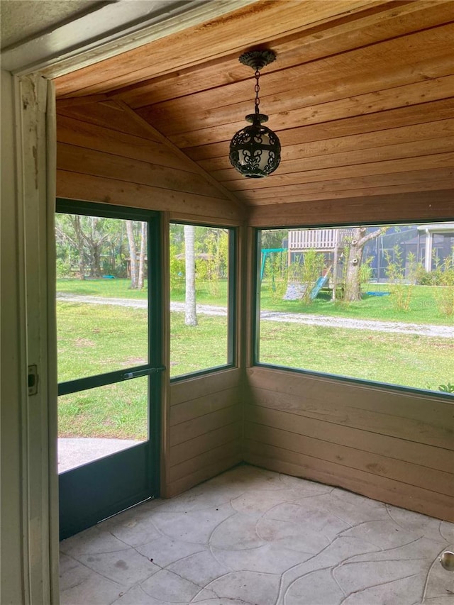 unfurnished sunroom with wooden ceiling and vaulted ceiling