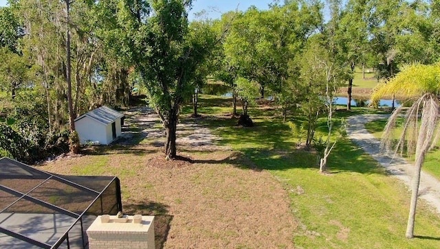 view of yard featuring a shed and a water view