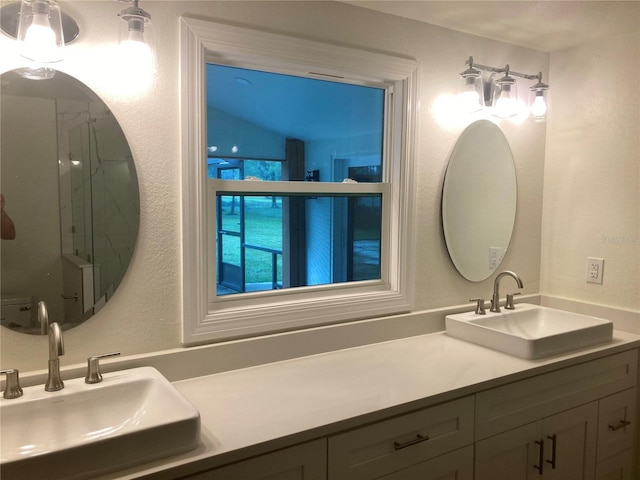 bathroom featuring walk in shower, vanity, and vaulted ceiling