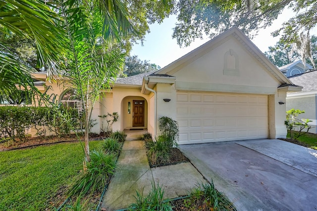 single story home featuring a garage and a front lawn