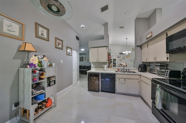 kitchen with black appliances, kitchen peninsula, sink, and a chandelier