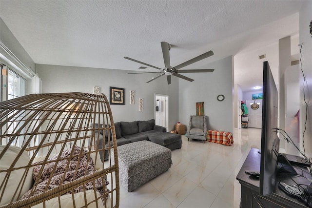 bedroom featuring ceiling fan and a textured ceiling