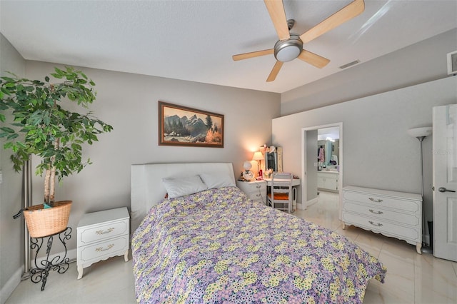 bedroom featuring a textured ceiling, ceiling fan, and connected bathroom