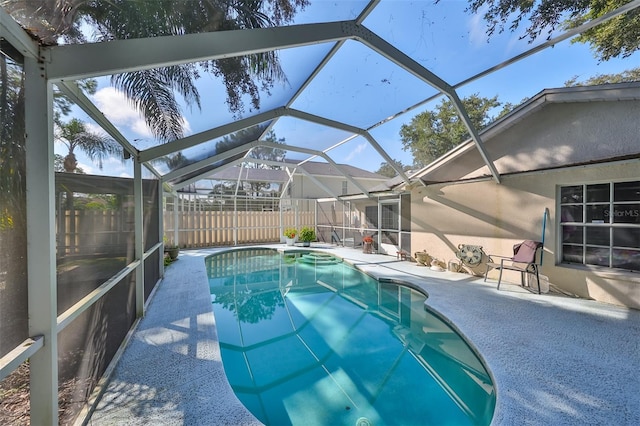 view of swimming pool with a lanai and a patio