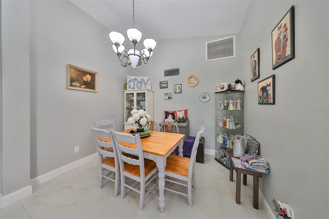 dining room with an inviting chandelier and high vaulted ceiling